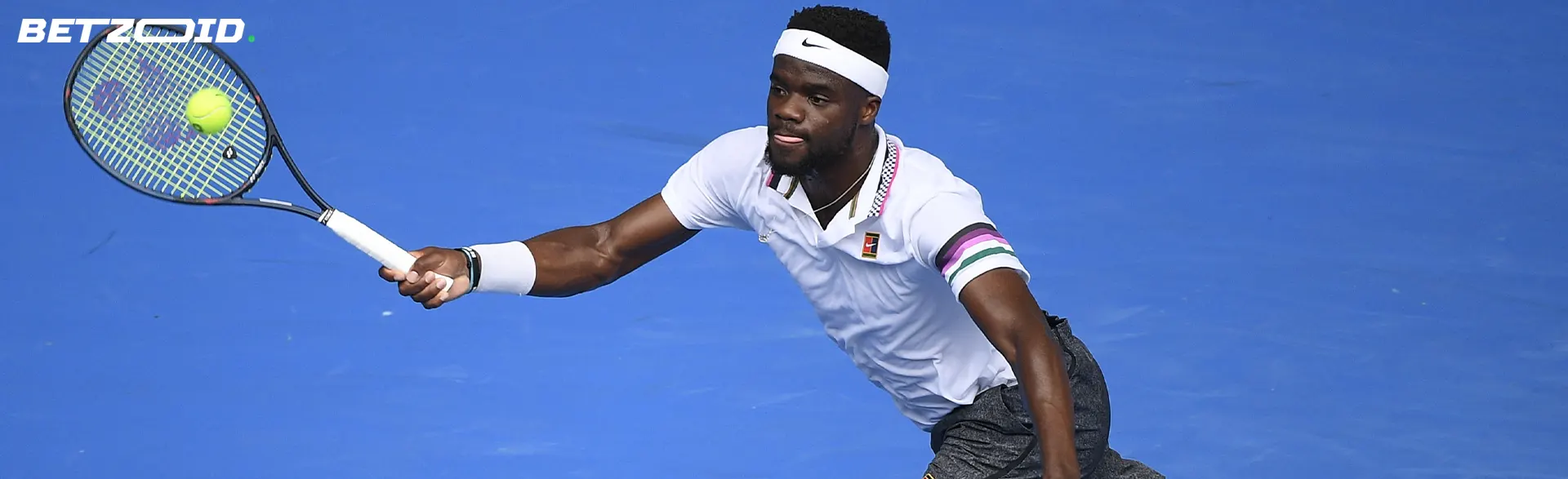 A tennis player hits the ball.