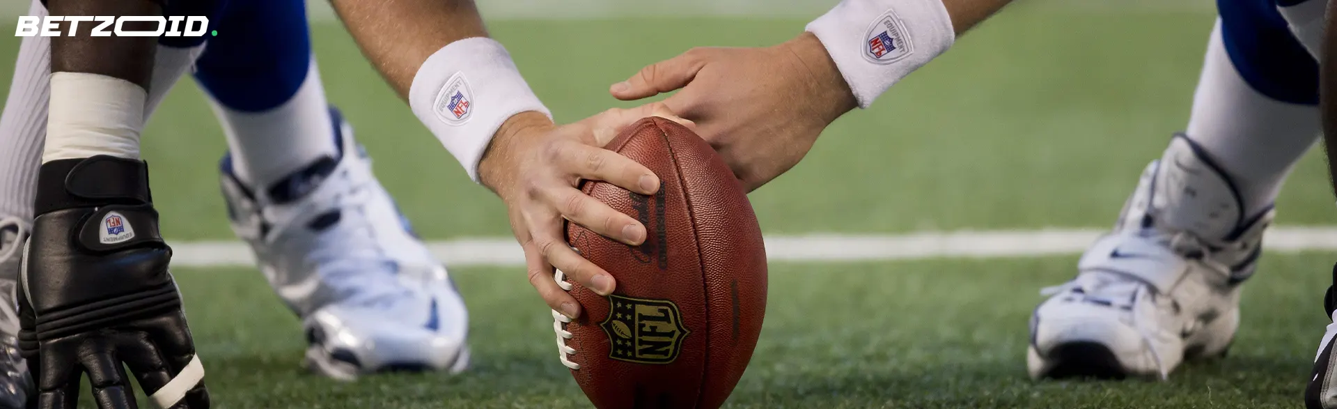 An American football player holds the ball before the start of the game.