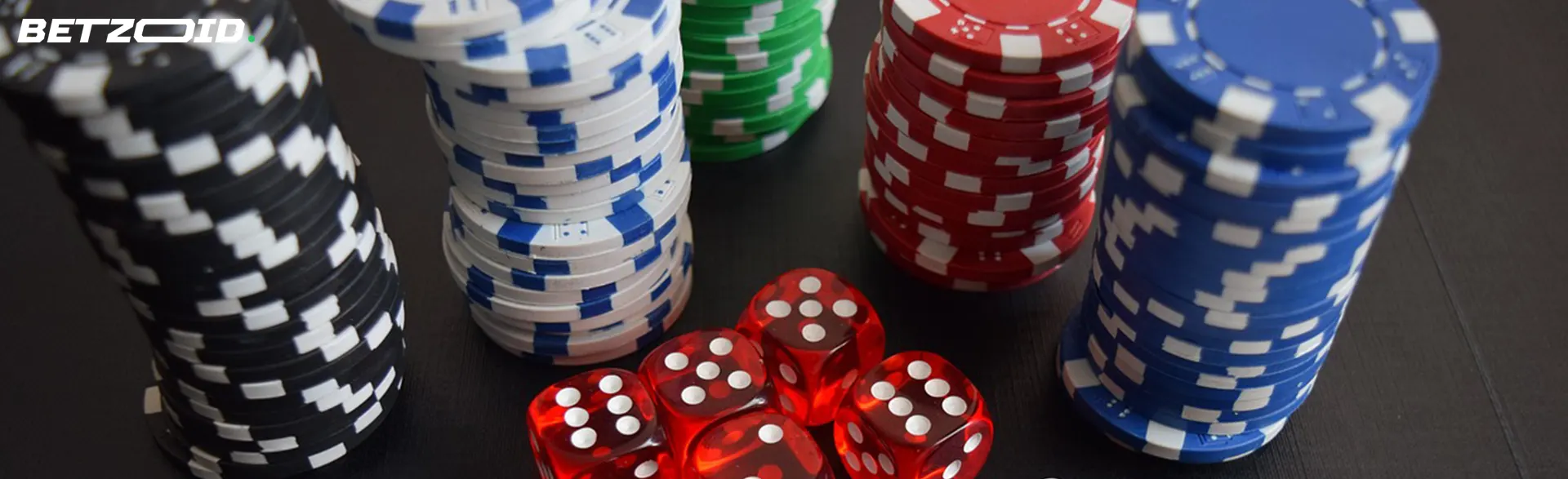 Stacks of chips next to dice.