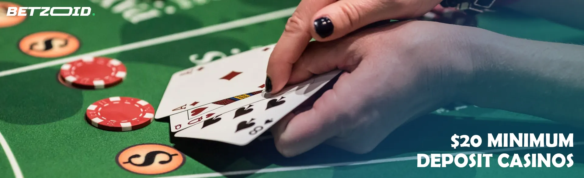 A player holds cards on the casino table.