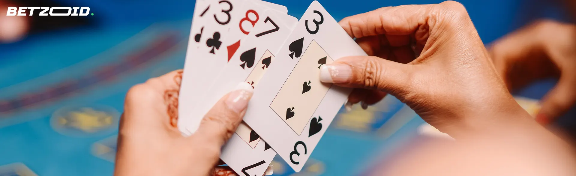 The player is holding cards on the background of the casino table.