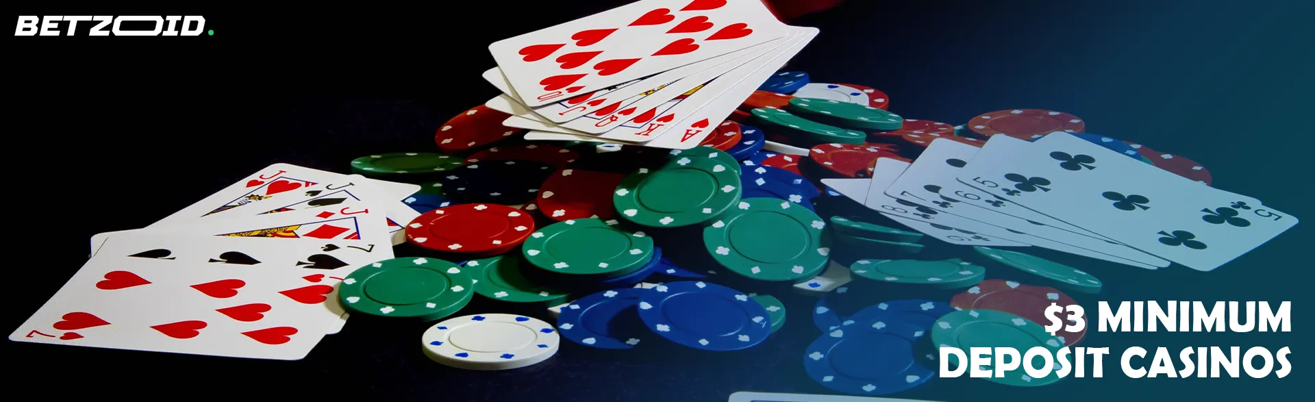 A bunch of casino chips and cards on a dark background. 