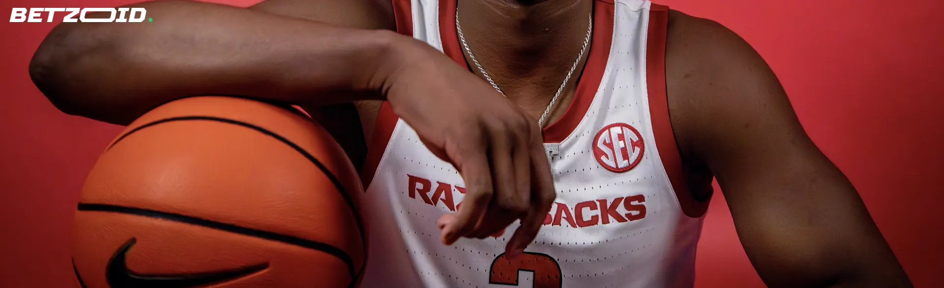 Basketball player holding a ball, highlighting the accessibility of 3 dollars deposit betting sites in Canada.