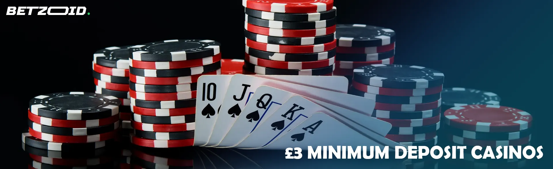 Pile of chips and cards on a dark background.