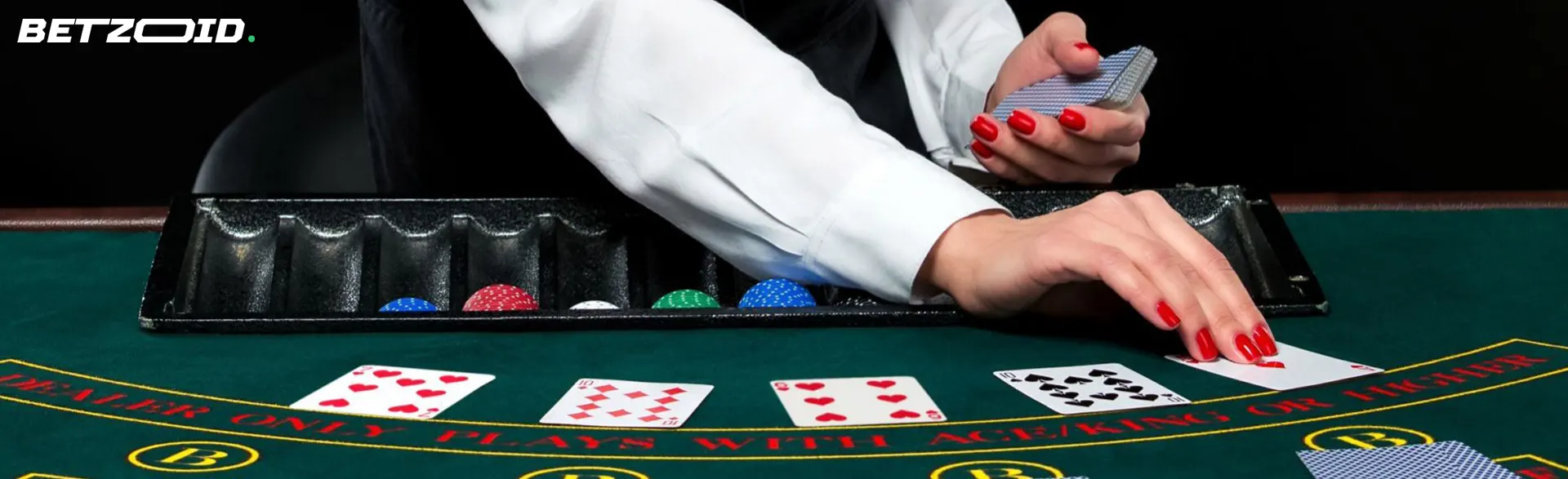 The croupier lays out the cards on the casino table.