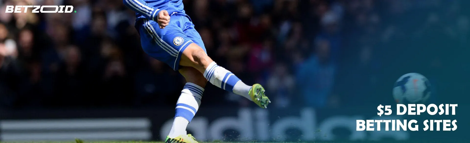 A football player kicks the ball during a game.