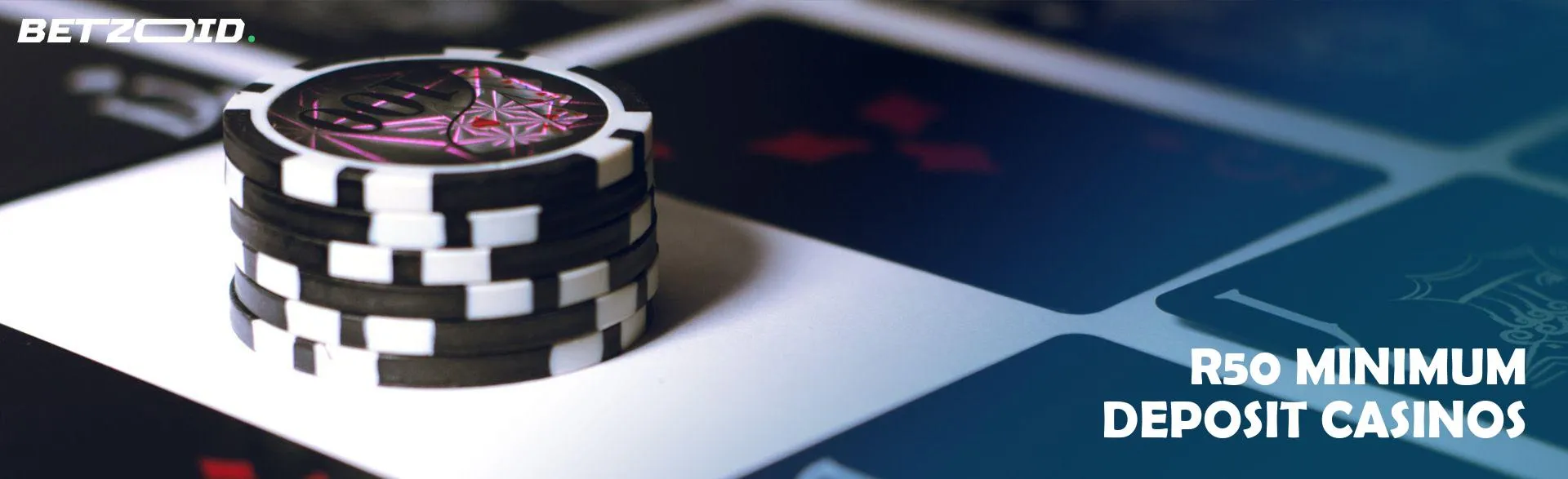Stack of chips next to black playing cards.