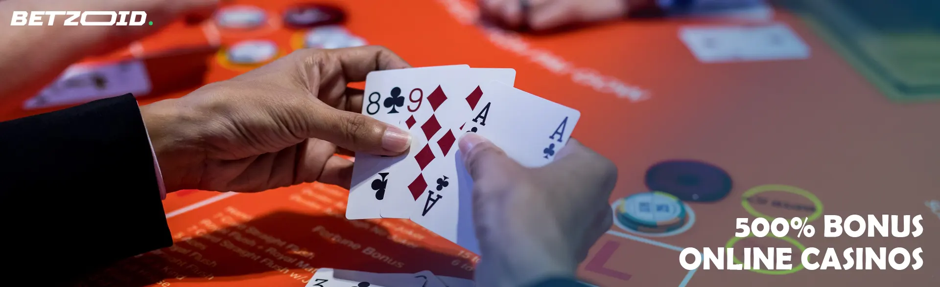 Cards in the hands of the player above the casino table.