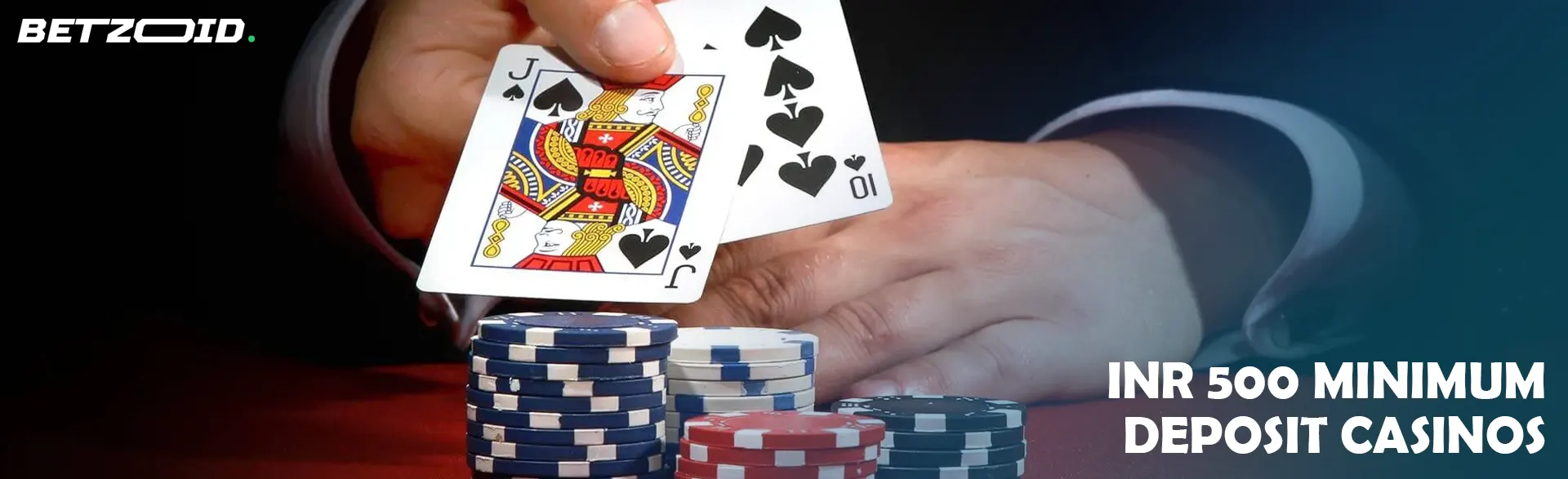 The player holds the cards next to the casino chips.