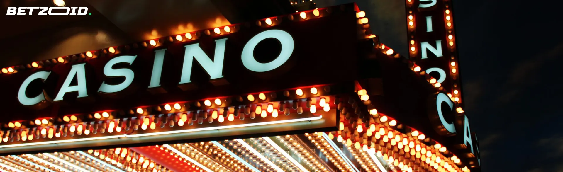 Illuminated casino sign with bright lamps.