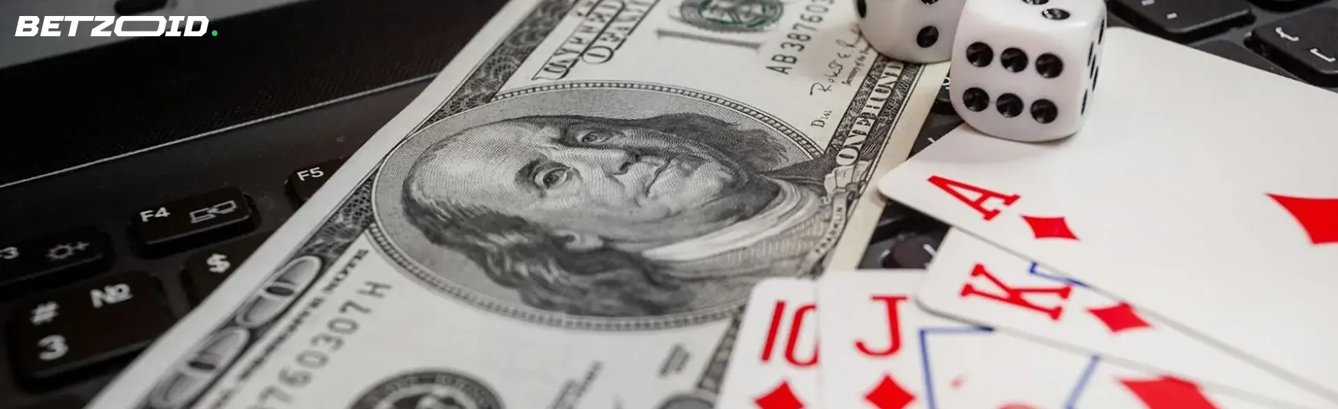 Cards, dice and bills lie on the keyboard.