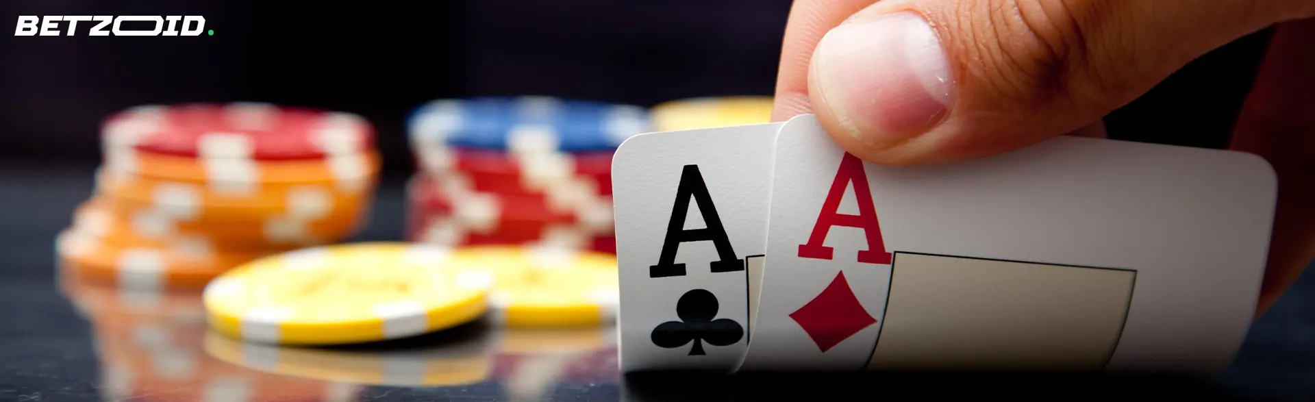 Two aces held by the player on a background of chips.
