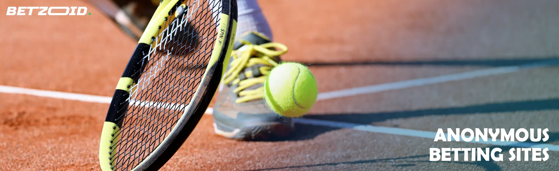 A tennis player with a racket hits the ball on the court.