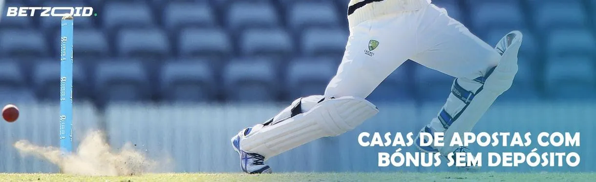 Um jogador de críquete acerta a bola no campo.