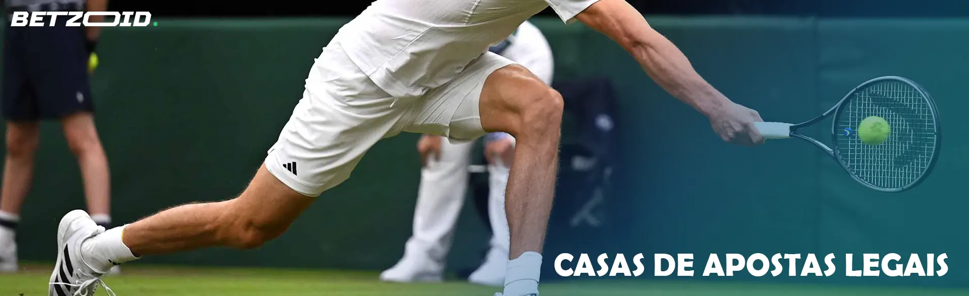 A male tennis player tries to hit a ball.