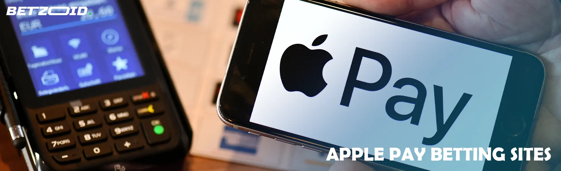 Smartphone with Apple Pay logo on terminal background.