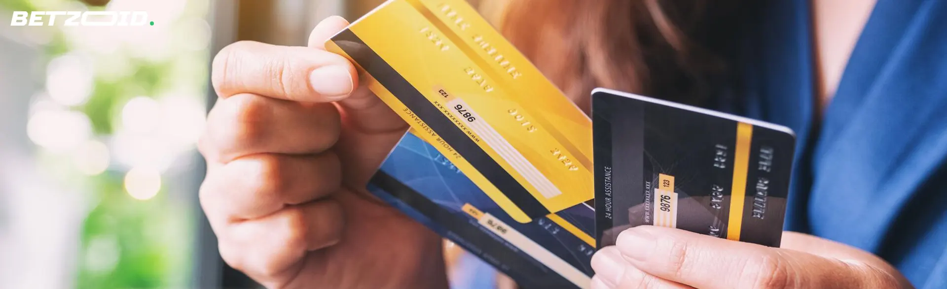 A man holds bank cards in his hands.