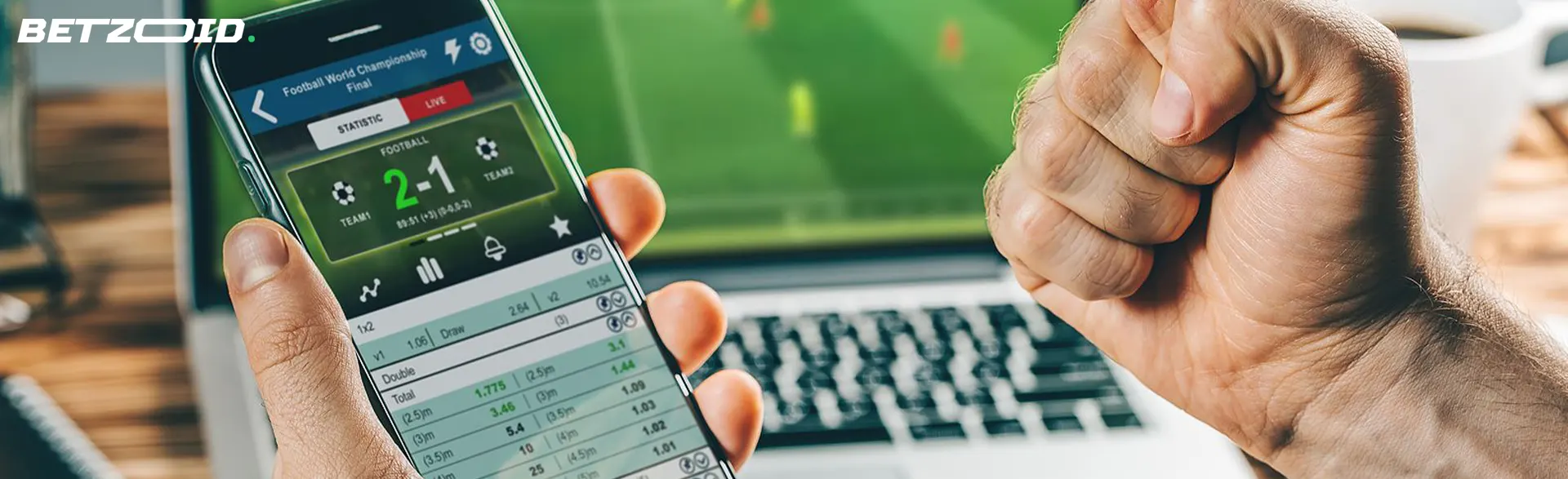 Smartphone with betting app in human hands.