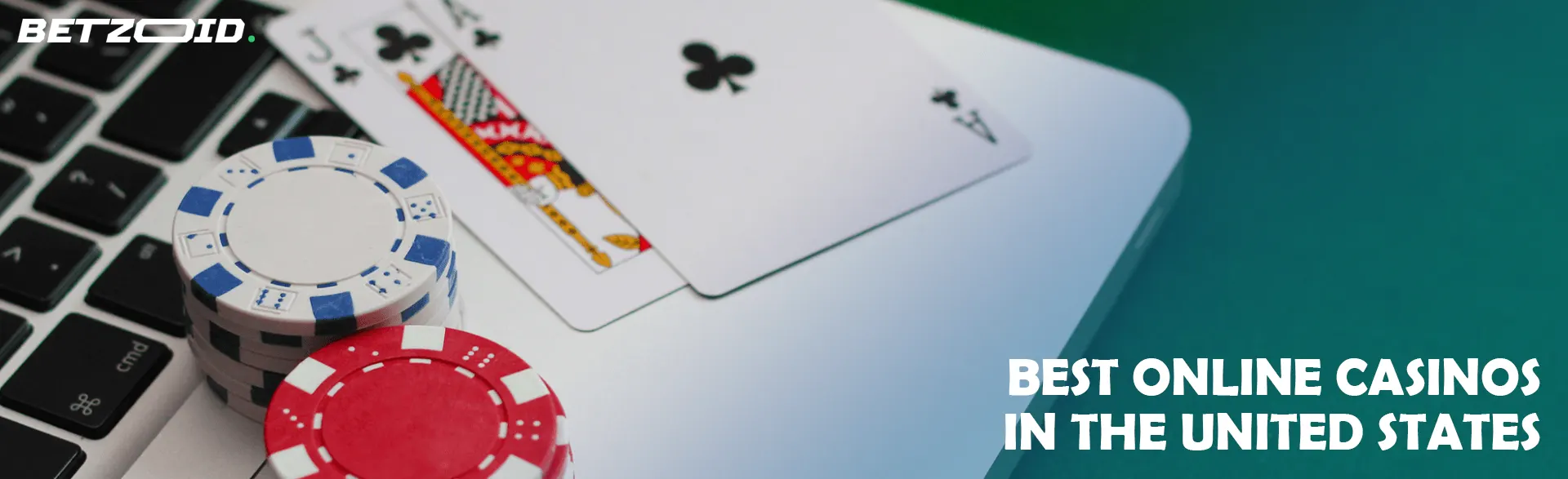 Casino cards and chips on the laptop keyboard.