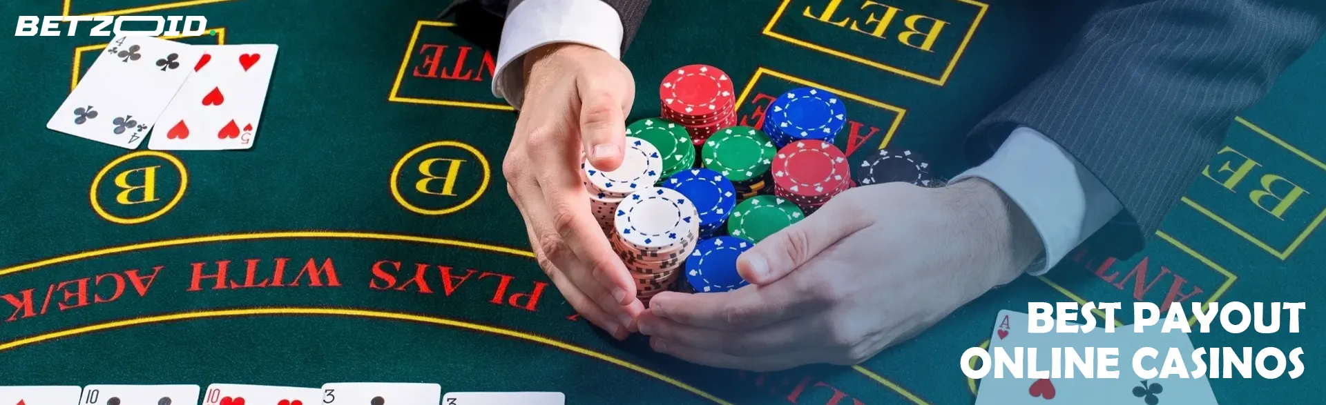 A player is holding a pile of chips on a casino table.