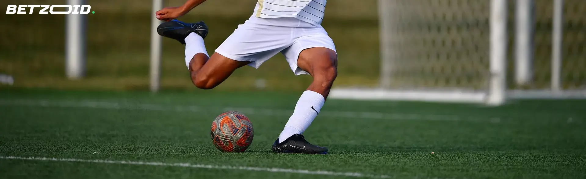 Soccer player preparing to kick a ball, showcasing the opportunities available on bet sites with minimum deposit 3 CAD in Canada.