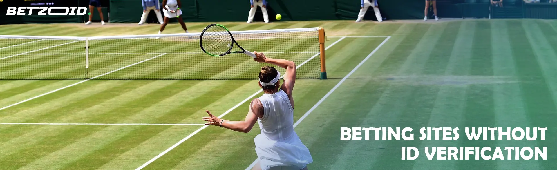 A tennis match where a player serves the ball on a grass court.