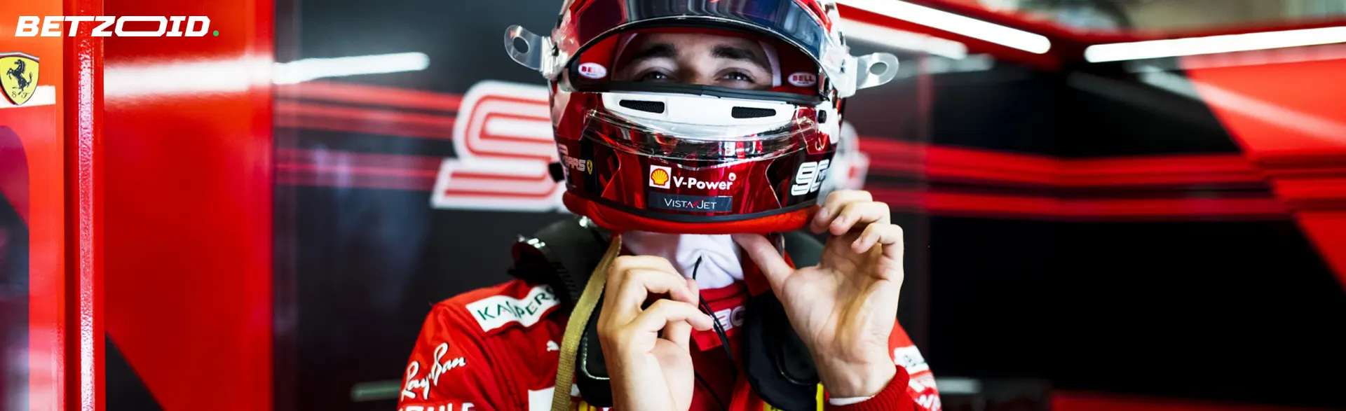 A Formula 1 driver puts on a helmet before the race.