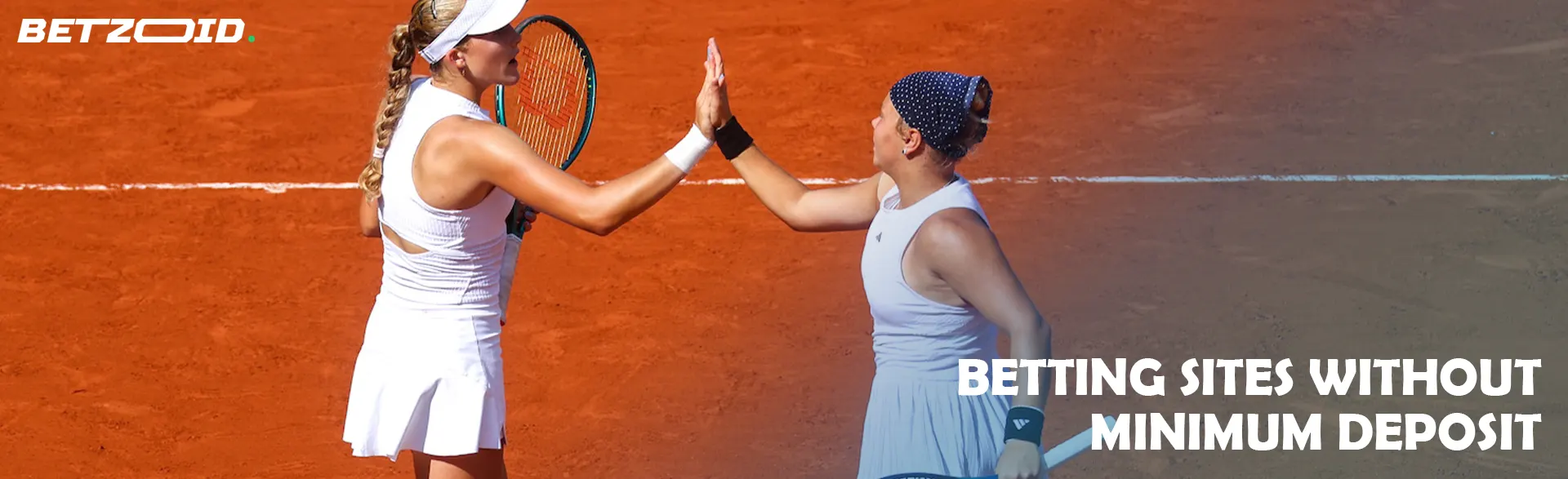 Two tennis players high five each other on the court.