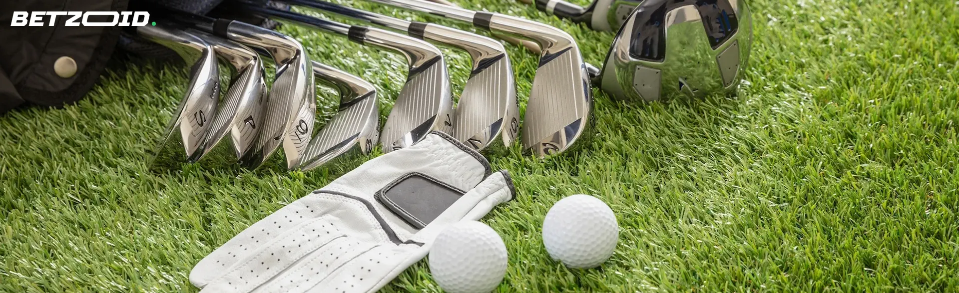 Golf equipment lies on the grass.