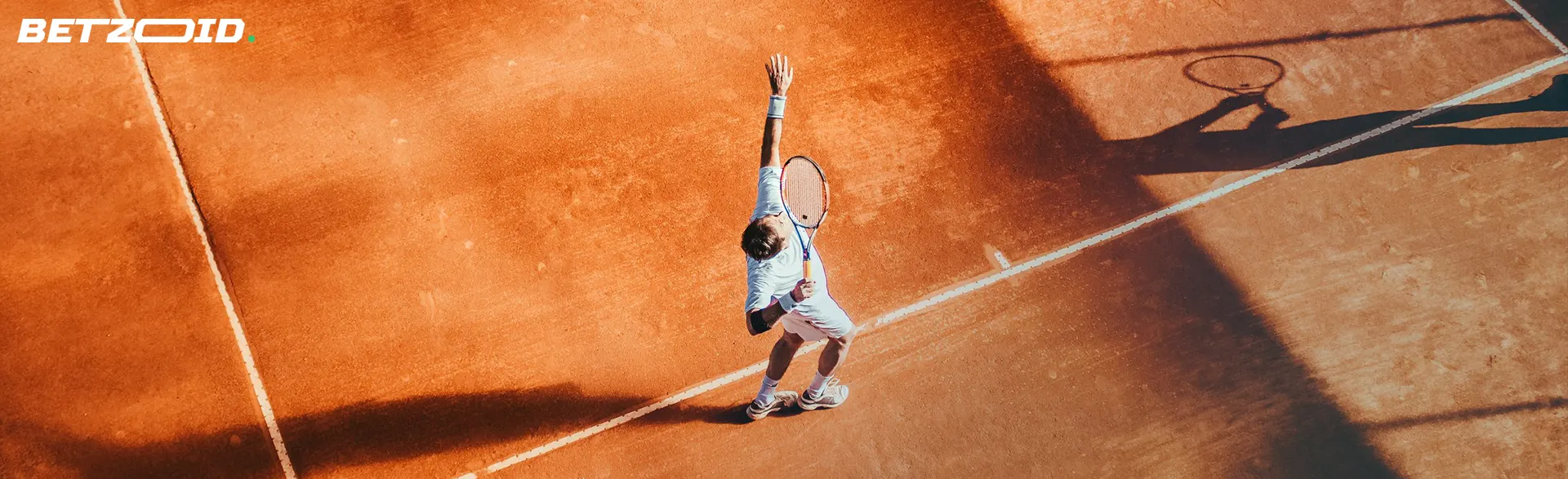 The player throws the tennis ball and starts the game.