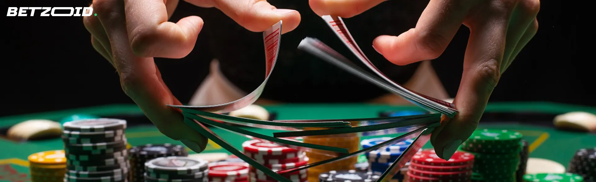 The player shuffles the cards over the chip table.