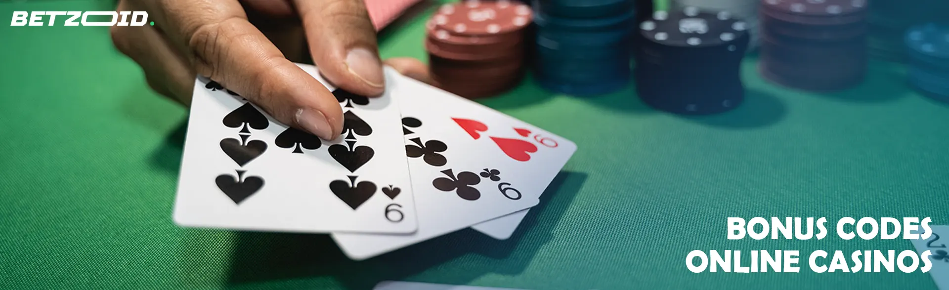 The player holds the cards next to the casino chips.