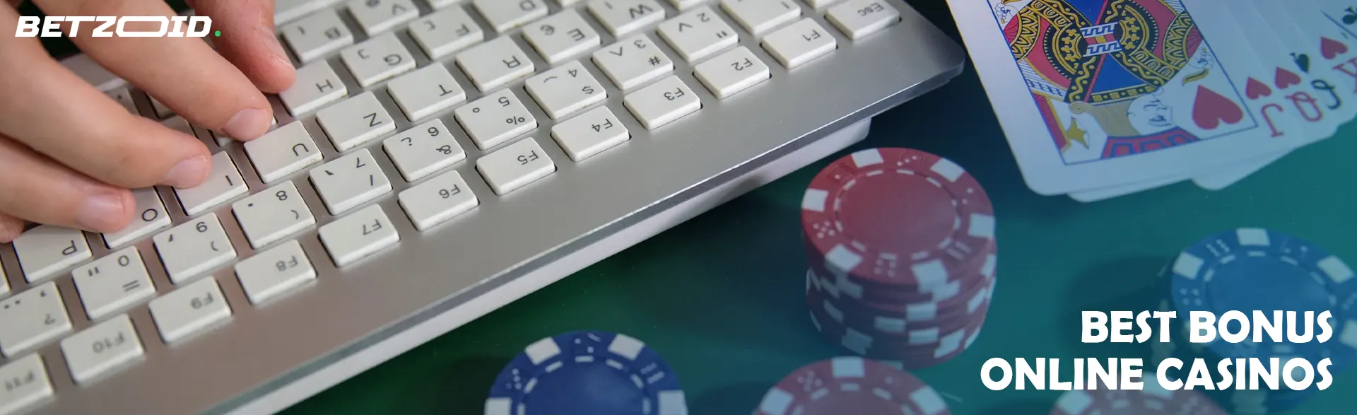 Casino cards and chips near the laptop keyboard.