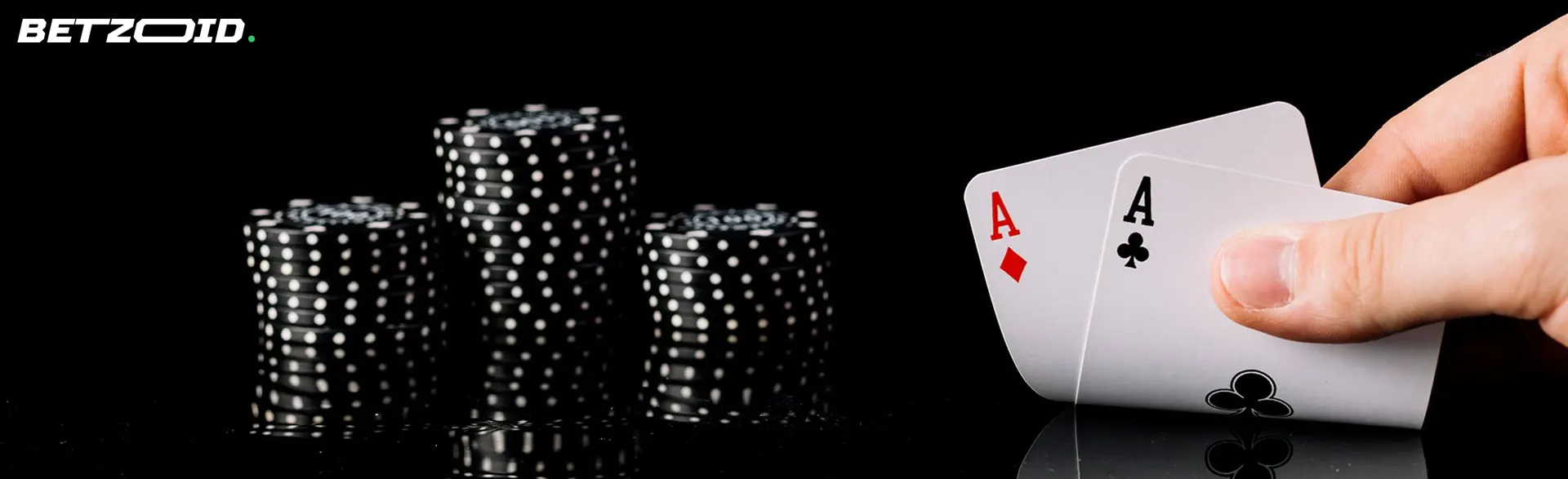 The player holds the cards next to the casino chips.