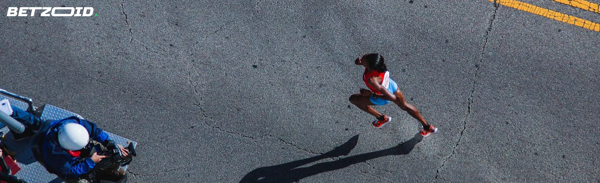 Aerial view of a female runner competing on a road.