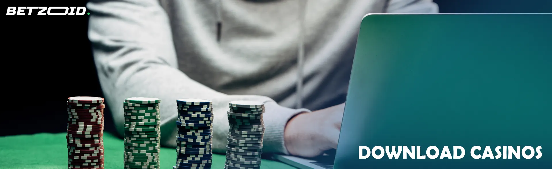A player in front of a laptop next to casino chips.