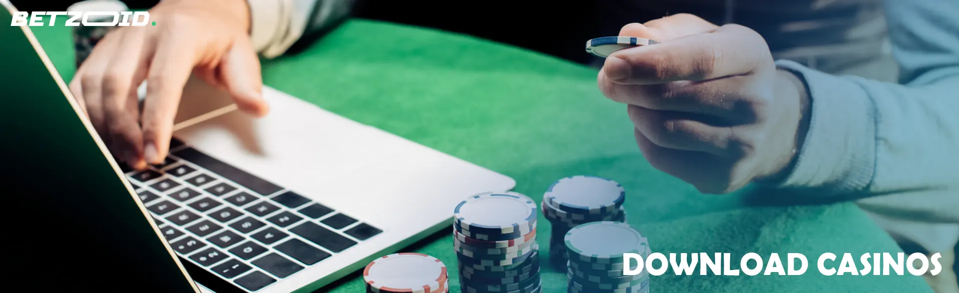 The player holds chips next to the laptop.