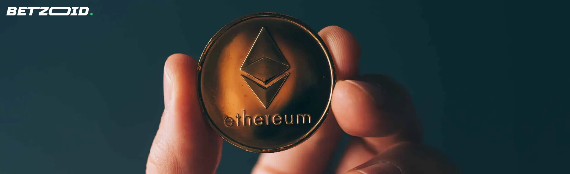 A person holds an Ethereum coin.