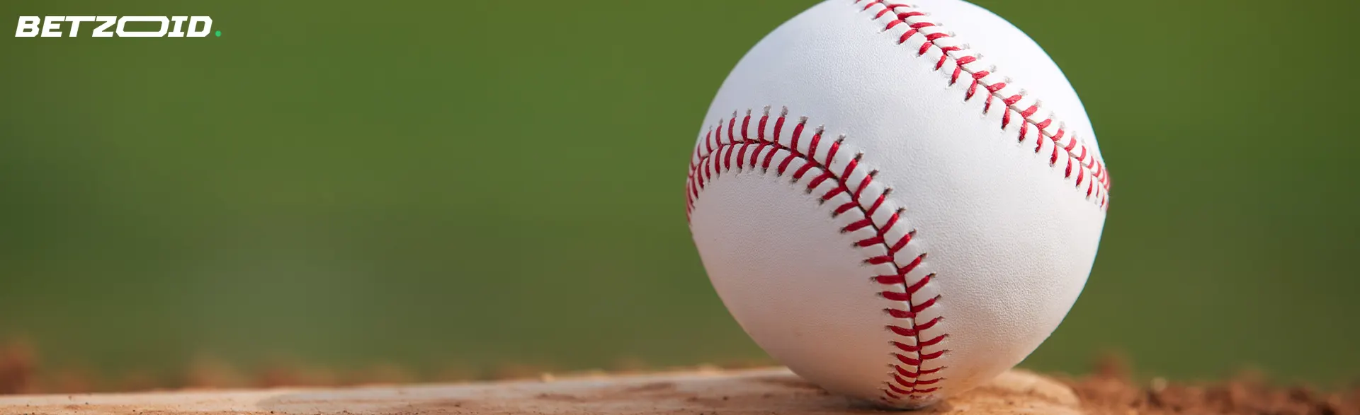 A baseball is lying on the grass.