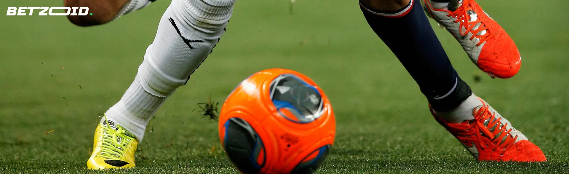 Two football players fight for the ball during the game.