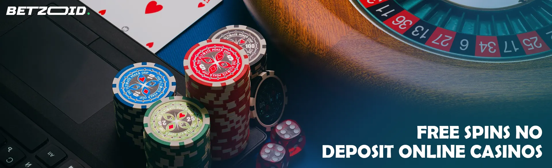 Roulette wheel, cards and chips on laptop keyboard.