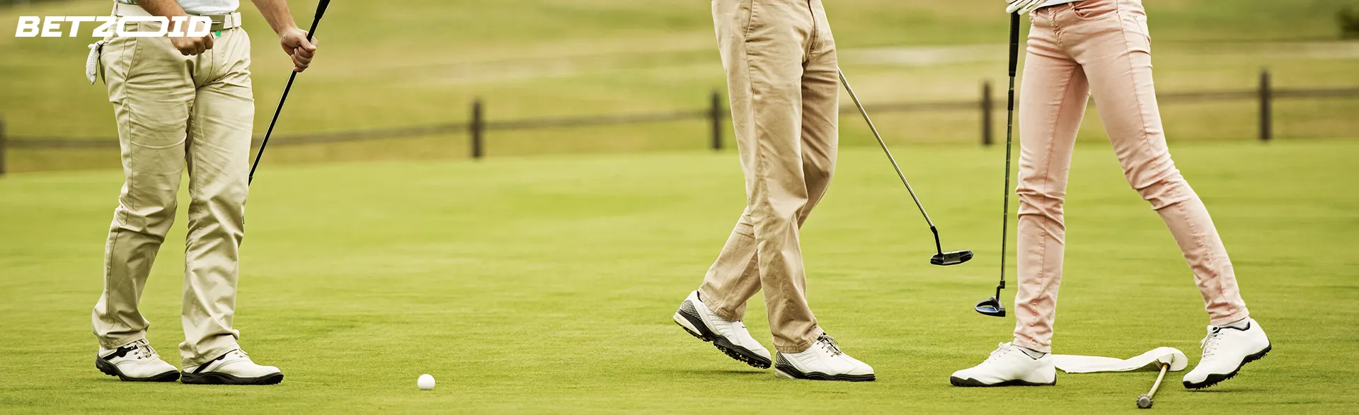 Legs of golfers on the course.