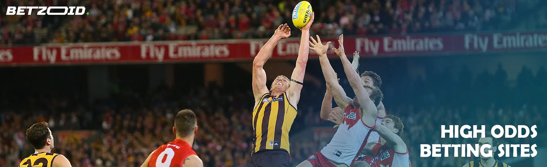 Players in a tense fight for the ball during a game of Australian football.