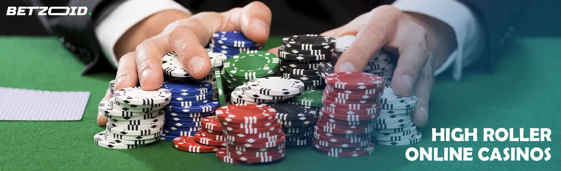 A player is holding a pile of chips on a casino table.