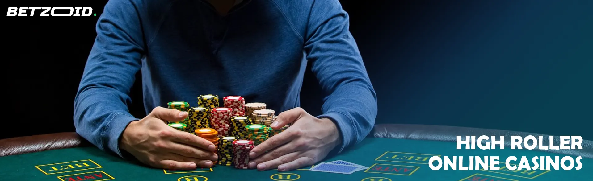 A player is holding a pile of chips on a casino table.