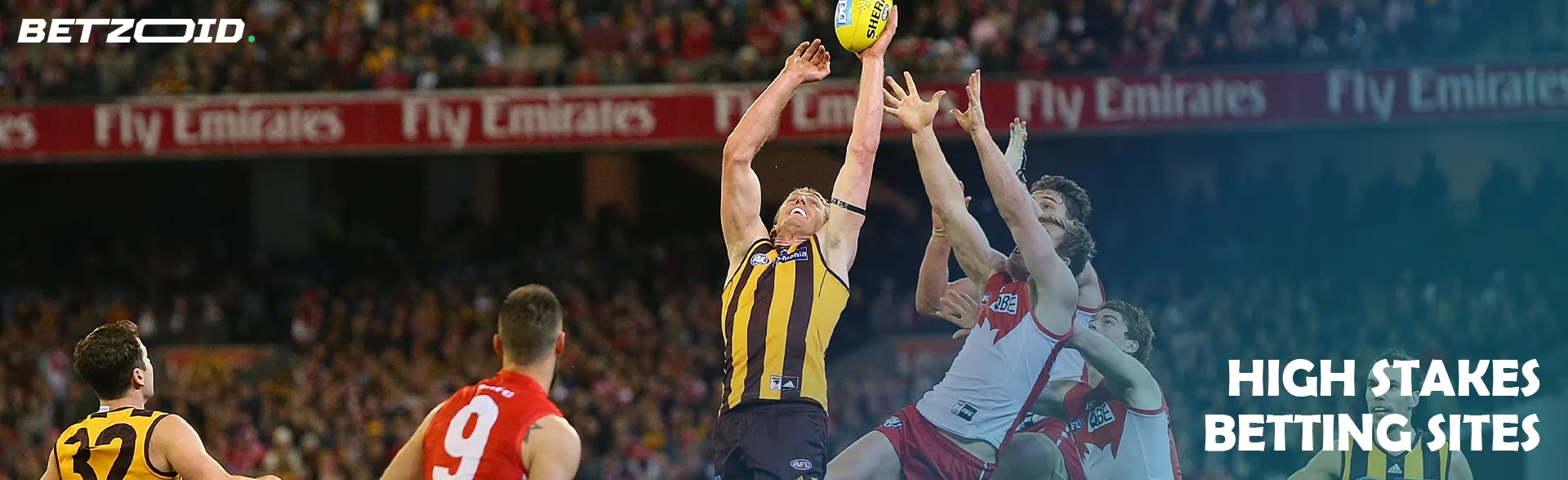 Australian football players fight for the ball during a game.