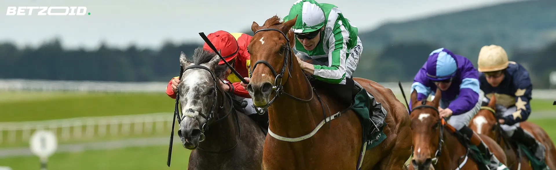 Jockeys on horses during horse racing.