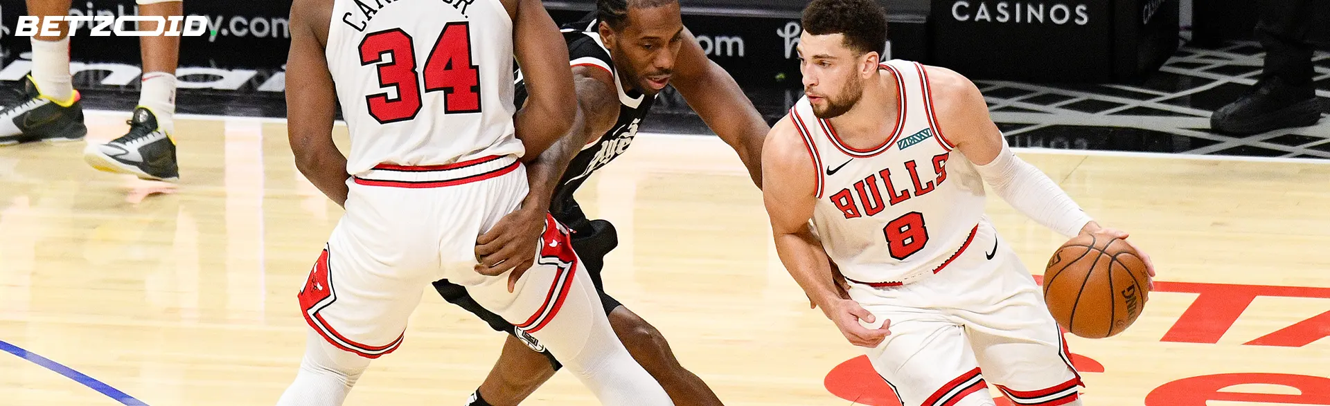 Basketball players fight for the ball during the match.