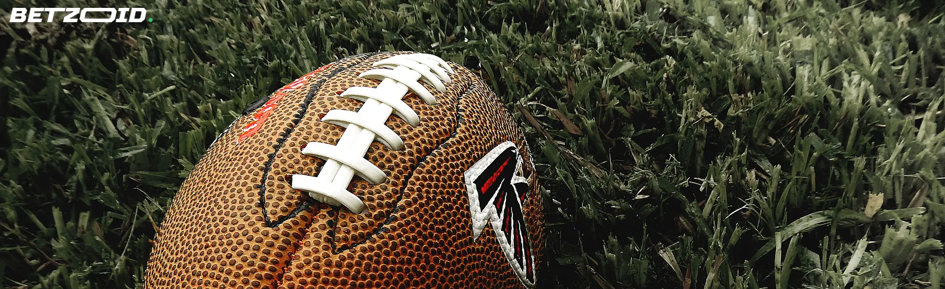 Worn football on grass highlighting instant withdrawal betting sites in Canada.