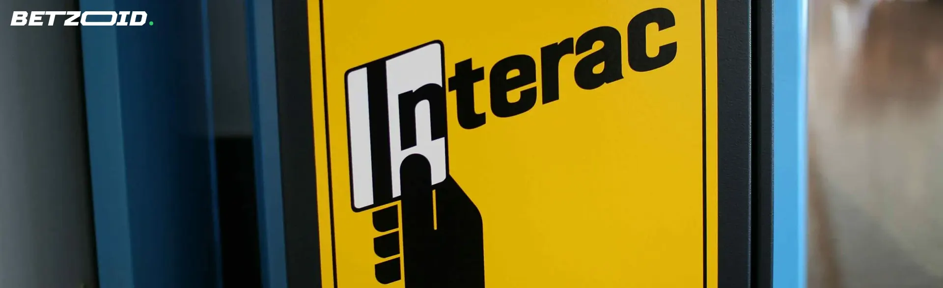 Yellow sign with Interac logo.